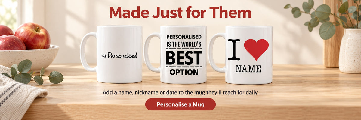 Made Just for Them. Add a name, nickname or date to the mug they'll reach for daily. Personalise a Mug. Three personalised mugs on a pale oak kitchen worktop beside a bowl of red apples.