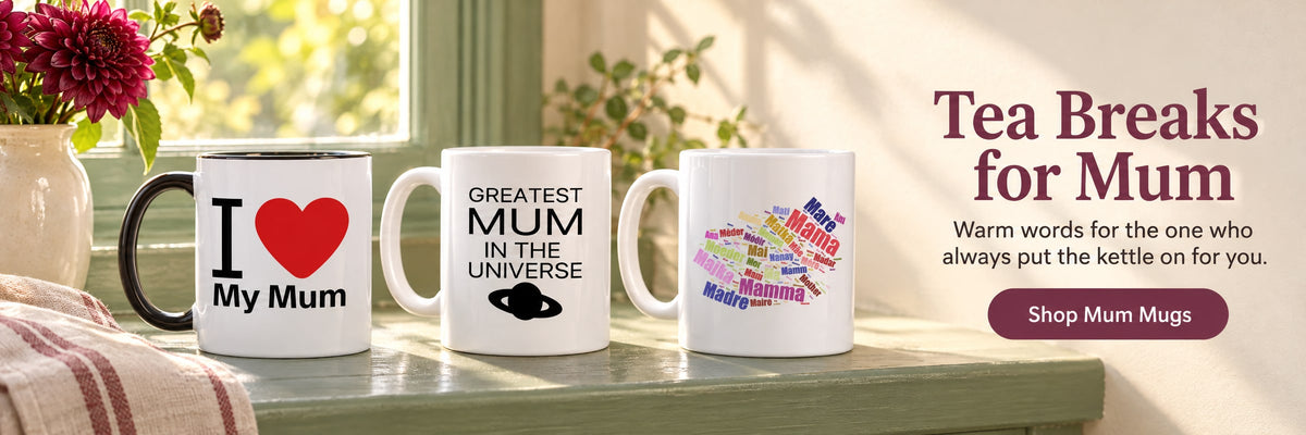 Tea Breaks for Mum. Warm words for the one who always put the kettle on for you. Shop Mum Mugs. Three mum mugs on a sage-green windowsill beside a vase of berry-coloured dahlias.